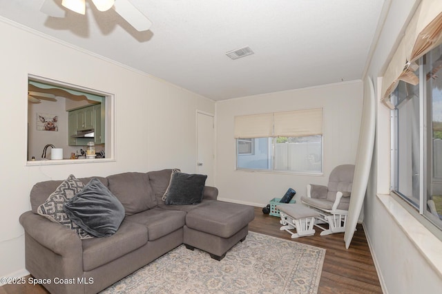858 Bianca Dr NE, Palm Bay, FL 32905 - living room with crown molding, wood finished floors, and a ceiling fan