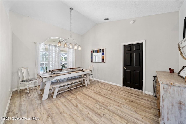3635 Manassas Ave, Melbourne, FL 32934 - dining space featuring light wood-style flooring, vaulted ceiling, and a chandelier