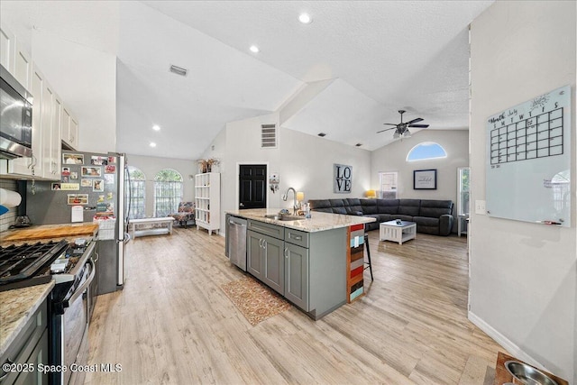 3635 Manassas Ave, Melbourne, FL 32934 - kitchen with stainless steel appliances, gray cabinets, ceiling fan, open floor plan, and lofted ceiling