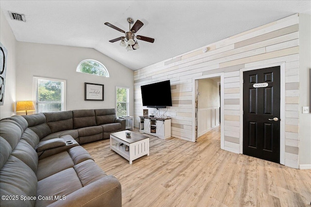 3635 Manassas Ave, Melbourne, FL 32934 - living area with ceiling fan, lofted ceiling, light wood-style floors, and wood walls