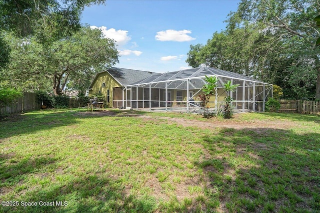 3635 Manassas Ave, Melbourne, FL 32934 - back of house with a fenced backyard and glass enclosure