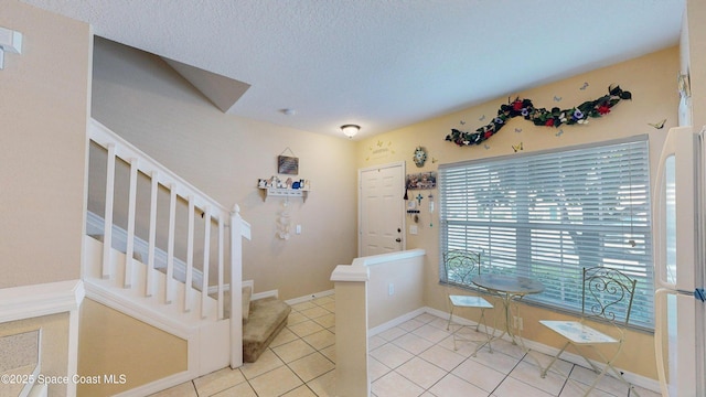 1347 Hampton Park Ln, Melbourne, FL 32940 - foyer entrance with stairs, light tile patterned flooring, and a textured ceiling