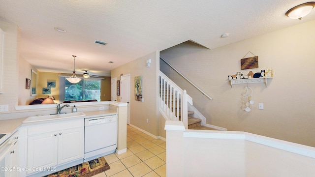1347 Hampton Park Ln, Melbourne, FL 32940 - kitchen featuring white dishwasher, white cabinets, light tile patterned flooring, hanging light fixtures, and light countertops