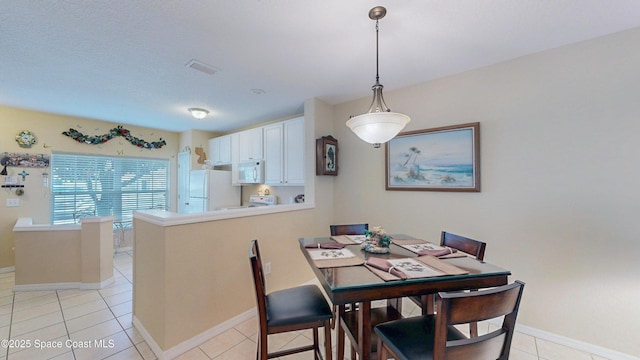 1347 Hampton Park Ln, Melbourne, FL 32940 - dining space with baseboards and light tile patterned floors