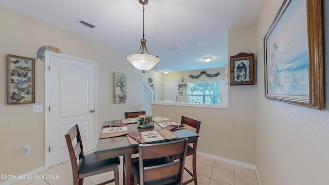 1347 Hampton Park Ln, Melbourne, FL 32940 - dining room with light tile patterned floors and baseboards