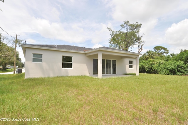1043 Walden Blvd SE, Palm Bay, FL 32909 - rear view of house with stucco siding and a yard