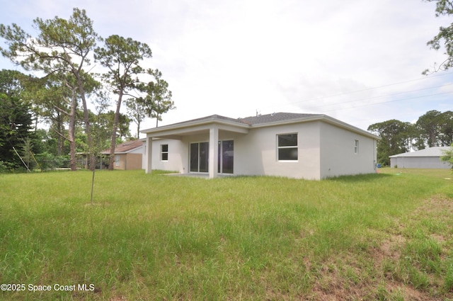 1043 Walden Blvd SE, Palm Bay, FL 32909 - back of property featuring stucco siding and a yard