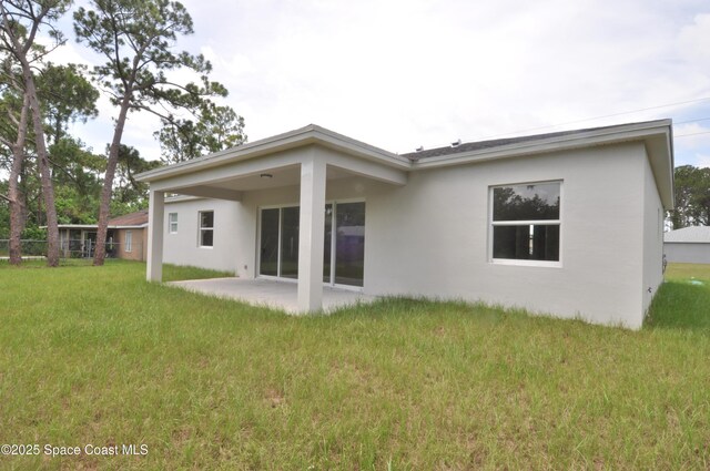 1043 Walden Blvd SE, Palm Bay, FL 32909 - back of house featuring stucco siding and a patio area