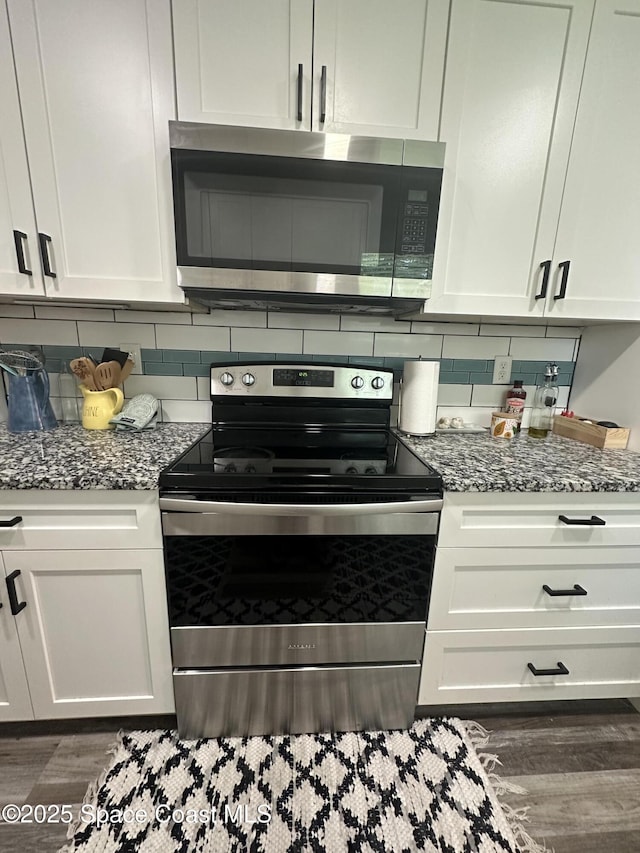 6240 Grissom Pkwy, Cocoa, FL 32927 - kitchen with appliances with stainless steel finishes, tasteful backsplash, and white cabinets