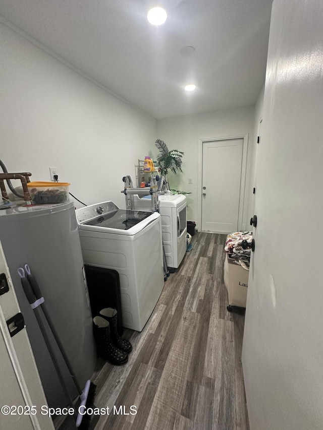 6240 Grissom Pkwy, Cocoa, FL 32927 - washroom featuring dark wood finished floors and washer and dryer