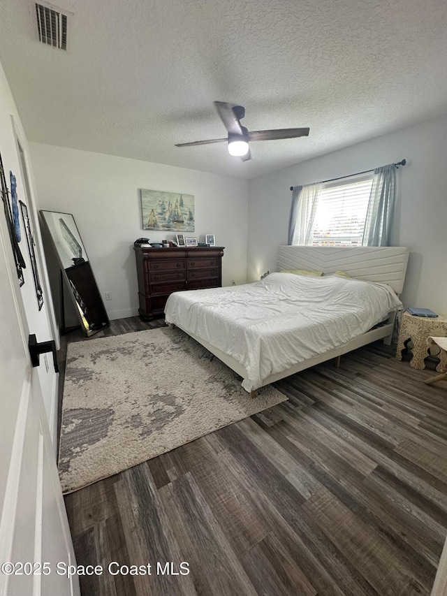 6240 Grissom Pkwy, Cocoa, FL 32927 - bedroom with wood finished floors, ceiling fan, and a textured ceiling