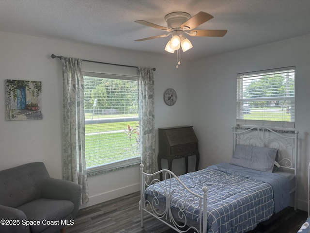 6240 Grissom Pkwy, Cocoa, FL 32927 - bedroom with wood finished floors, multiple windows, and a ceiling fan