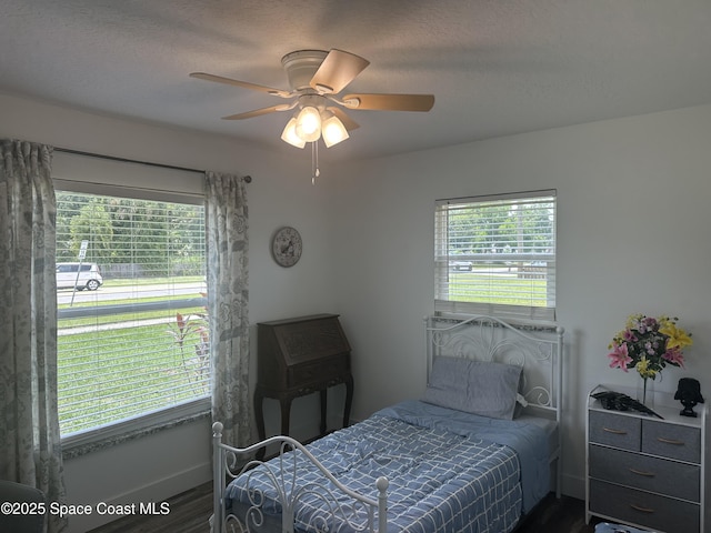 6240 Grissom Pkwy, Cocoa, FL 32927 - bedroom featuring dark wood-type flooring, multiple windows, and a ceiling fan