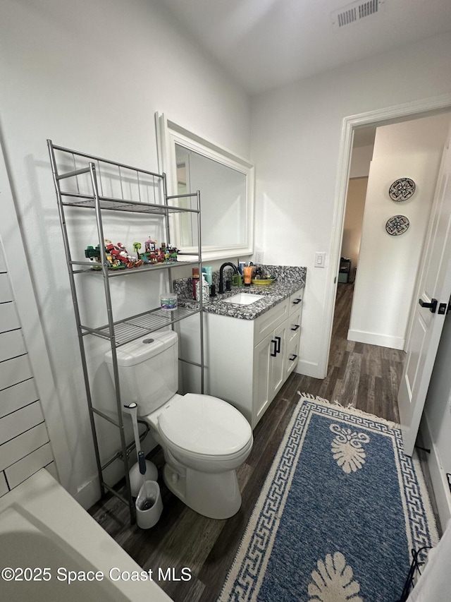 6240 Grissom Pkwy, Cocoa, FL 32927 - full bathroom featuring wood finished floors, vanity, and a bathtub