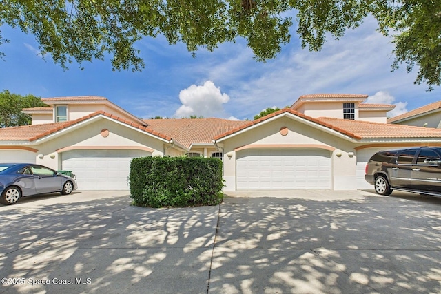 1720 Minutemen Cswy Unit 3, Cocoa Beach, FL 32931 - mediterranean / spanish home featuring driveway, an attached garage, stucco siding, and a tile roof
