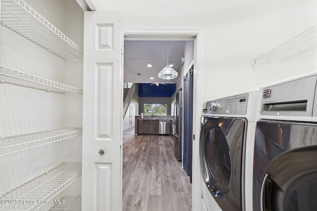 1720 Minutemen Cswy Unit 3, Cocoa Beach, FL 32931 - laundry area featuring washer and clothes dryer and wood finished floors