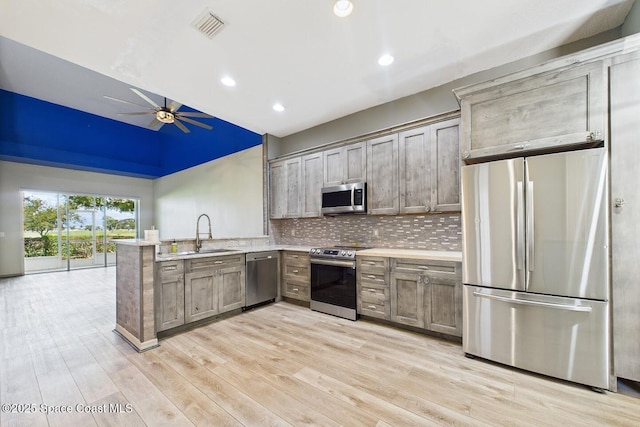1720 Minutemen Cswy Unit 3, Cocoa Beach, FL 32931 - kitchen with stainless steel appliances, a ceiling fan, a peninsula, light countertops, and tasteful backsplash