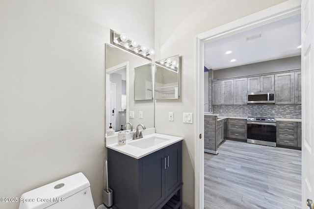 1720 Minutemen Cswy Unit 3, Cocoa Beach, FL 32931 - bathroom with vanity, tasteful backsplash, and wood finished floors