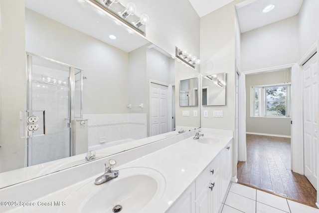 1720 Minutemen Cswy Unit 3, Cocoa Beach, FL 32931 - bathroom with double vanity, a stall shower, a garden tub, and tile patterned flooring
