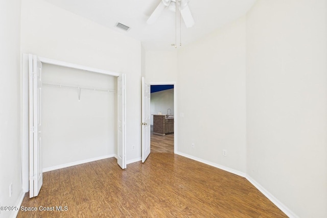 1720 Minutemen Cswy Unit 3, Cocoa Beach, FL 32931 - unfurnished bedroom featuring wood finished floors, a closet, and a ceiling fan
