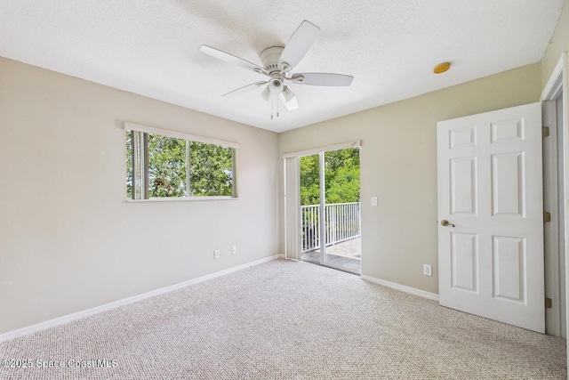 1720 Minutemen Cswy Unit 3, Cocoa Beach, FL 32931 - unfurnished bedroom with access to exterior, carpet, ceiling fan, and a textured ceiling