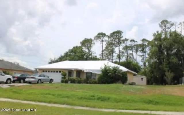 3589 N Chamberlain Blvd, North Port, FL 34286 - ranch-style house with an attached garage and a front yard