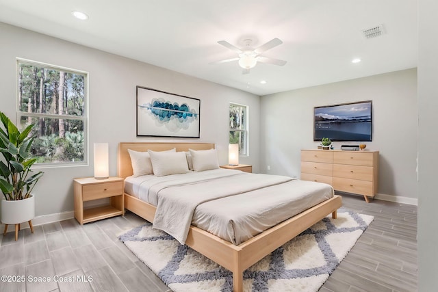 1049 Towhlen St SE, Palm Bay, FL 32909 - bedroom with multiple windows, wood tiled floors, recessed lighting, and ceiling fan