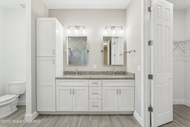 1049 Towhlen St SE, Palm Bay, FL 32909 - bathroom featuring wood finish floors, double vanity, and a shower
