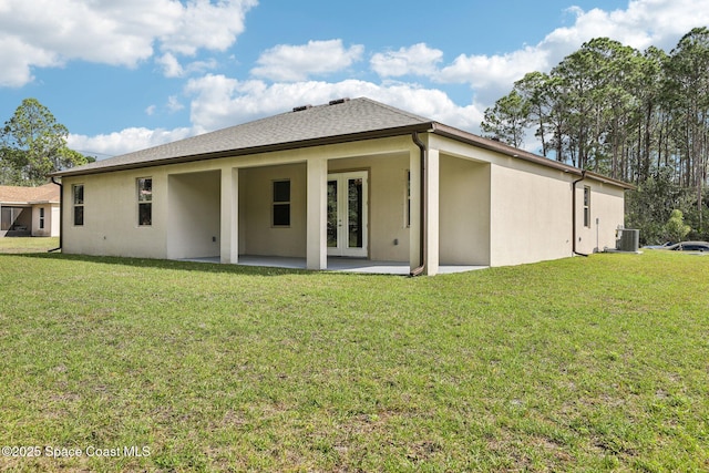 1049 Towhlen St SE, Palm Bay, FL 32909 - rear view of property featuring french doors, stucco siding, a patio, and a yard