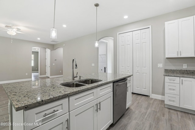 1049 Towhlen St SE, Palm Bay, FL 32909 - kitchen with dishwasher, arched walkways, a ceiling fan, recessed lighting, and white cabinetry