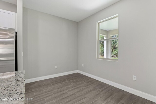 1049 Towhlen St SE, Palm Bay, FL 32909 - empty room featuring baseboards and dark wood-type flooring