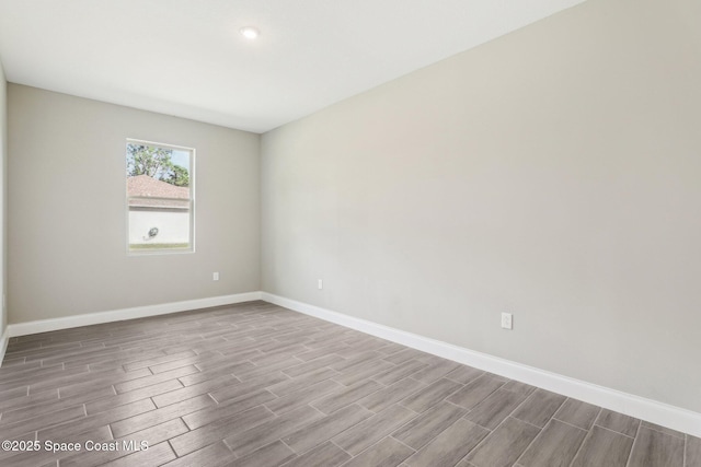 1049 Towhlen St SE, Palm Bay, FL 32909 - empty room featuring wood tiled floors and baseboards
