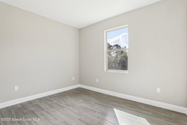 1049 Towhlen St SE, Palm Bay, FL 32909 - spare room with baseboards and wood tiled floors