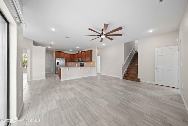 3645 Salt Marsh Cir, West Melbourne, FL 32904 - unfurnished living room featuring ceiling fan, recessed lighting, stairway, and arched walkways