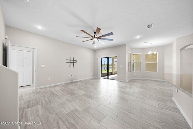 3645 Salt Marsh Cir, West Melbourne, FL 32904 - unfurnished room with a ceiling fan, a chandelier, arched walkways, recessed lighting, and a textured ceiling