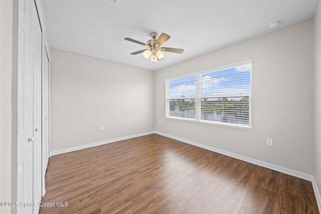 3645 Salt Marsh Cir, West Melbourne, FL 32904 - unfurnished room featuring a smoke detector, dark wood finished floors, and a ceiling fan