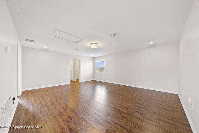 3645 Salt Marsh Cir, West Melbourne, FL 32904 - unfurnished room with wood finished floors, attic access, and arched walkways