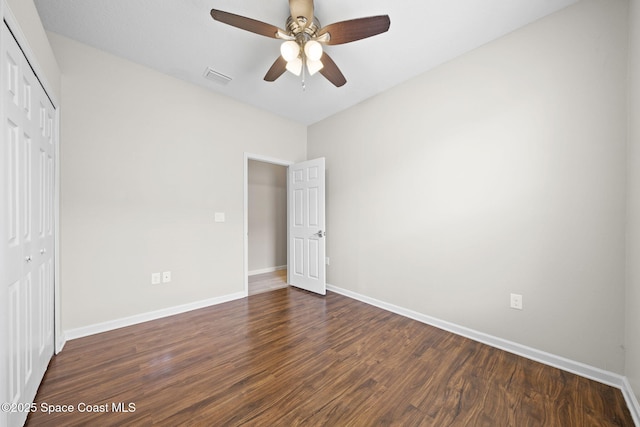 3645 Salt Marsh Cir, West Melbourne, FL 32904 - unfurnished bedroom featuring a closet, dark wood-type flooring, and a ceiling fan