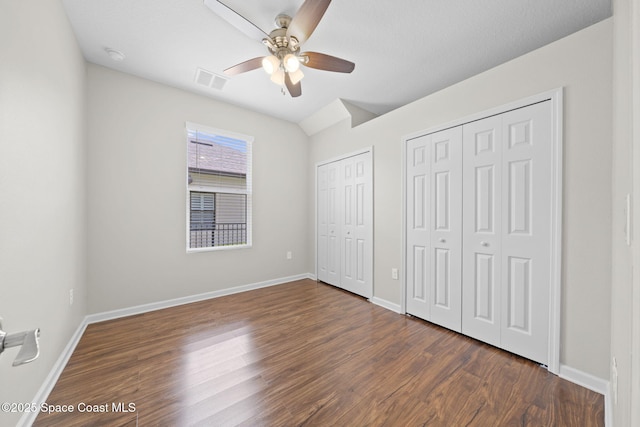 3645 Salt Marsh Cir, West Melbourne, FL 32904 - unfurnished bedroom featuring two closets, dark wood-style floors, and a ceiling fan