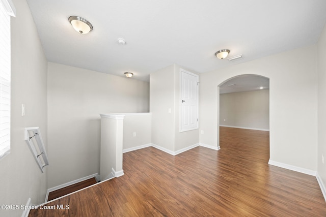 3645 Salt Marsh Cir, West Melbourne, FL 32904 - spare room with arched walkways, wood finished floors, and a smoke detector