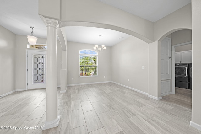 3645 Salt Marsh Cir, West Melbourne, FL 32904 - entryway featuring washer / dryer, arched walkways, light wood-type flooring, and a chandelier