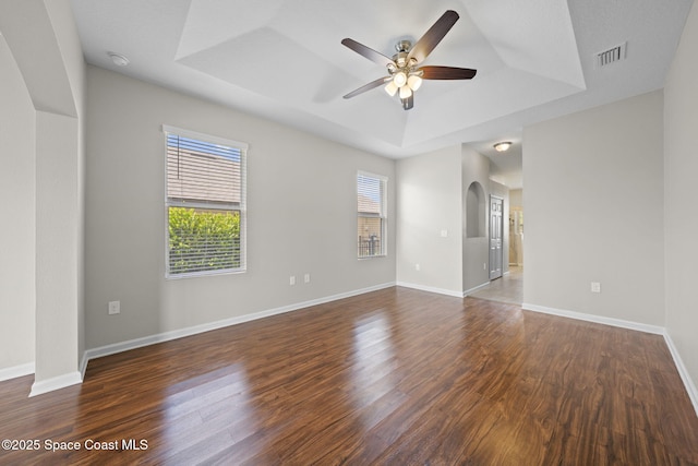 3645 Salt Marsh Cir, West Melbourne, FL 32904 - unfurnished room featuring a tray ceiling, plenty of natural light, wood finished floors, and ceiling fan