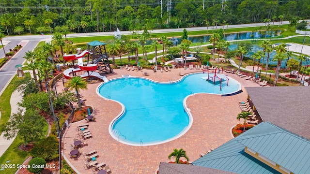 3645 Salt Marsh Cir, West Melbourne, FL 32904 - community pool with a water slide and view of wooded area