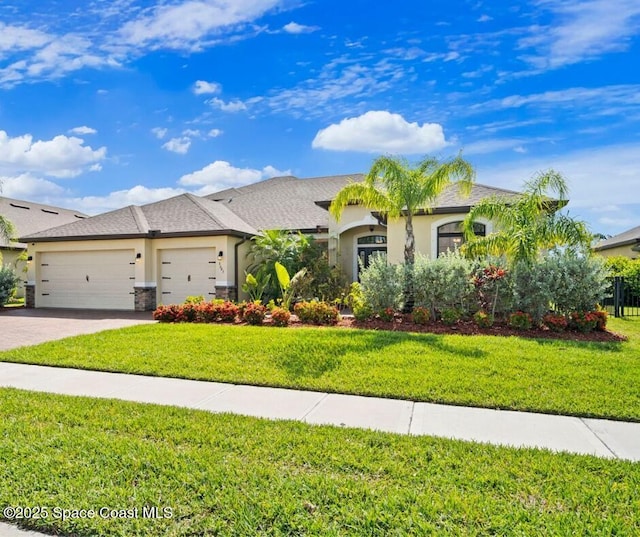 3645 Salt Marsh Cir, West Melbourne, FL 32904 - view of front of home featuring an attached garage, driveway, stucco siding, and a front yard