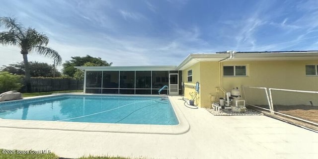 699 Bimini Rd, Satellite Beach, FL 32937 - view of swimming pool featuring a sunroom and a patio