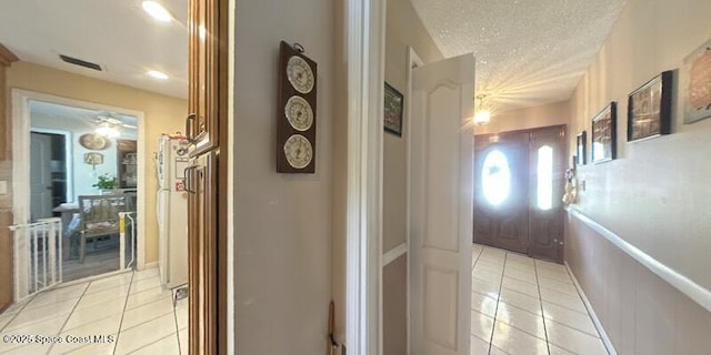 699 Bimini Rd, Satellite Beach, FL 32937 - hall with light tile patterned flooring and a textured ceiling