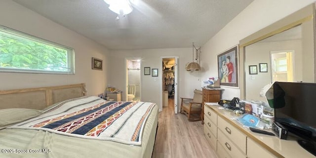 699 Bimini Rd, Satellite Beach, FL 32937 - bedroom with a walk in closet, light wood-type flooring, and ensuite bathroom