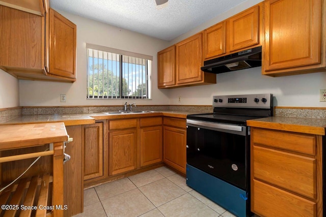 1572 Talavera St SE, Palm Bay, FL 32909 - kitchen featuring electric stove, under cabinet range hood, brown cabinetry, a textured ceiling, and light tile patterned flooring
