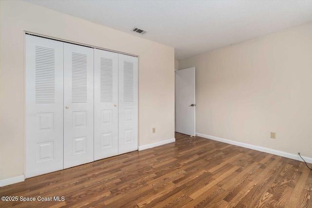 1572 Talavera St SE, Palm Bay, FL 32909 - unfurnished bedroom featuring wood finished floors and a closet