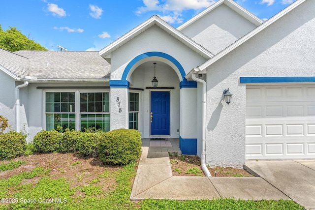 878 Croton Rd, Rockledge, FL 32955 - entrance to property featuring an attached garage and stucco siding